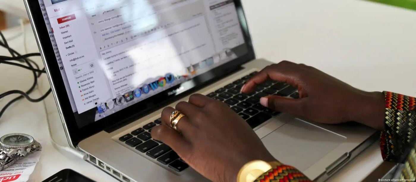 Hands typing on a laptop