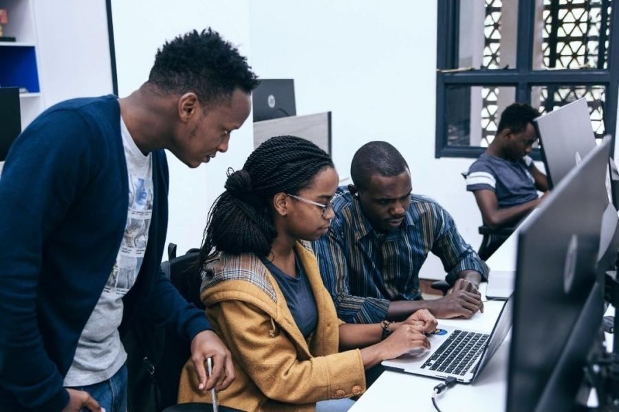 A development team working together at their screens