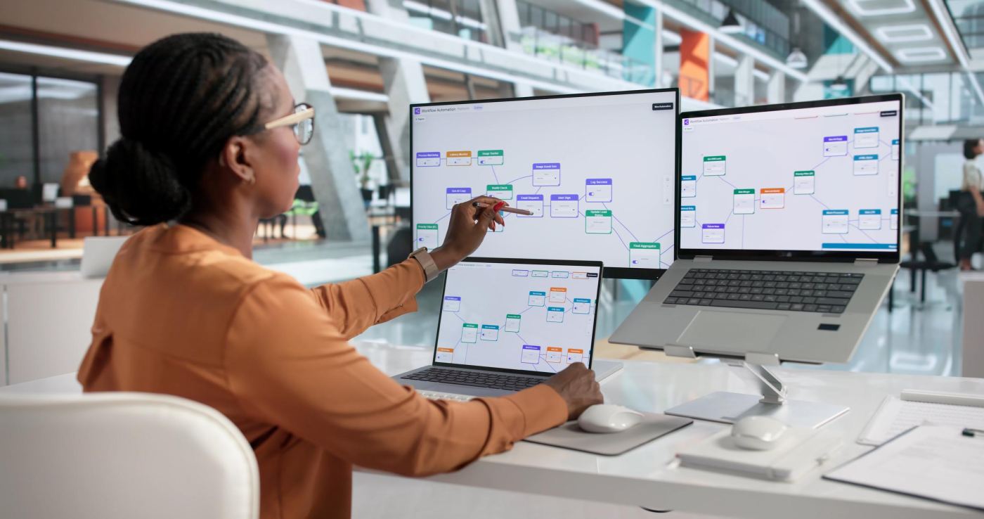 A team member planning work across several screens