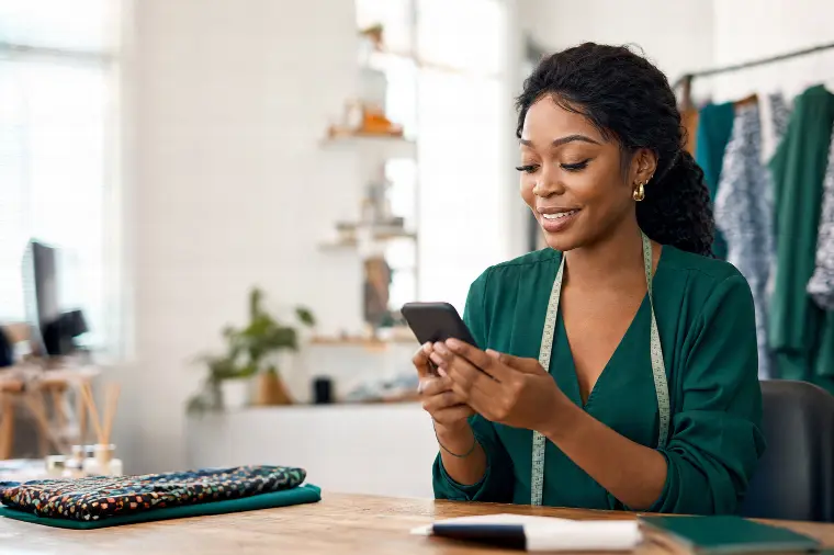 Business owner reading a customer message on her phone